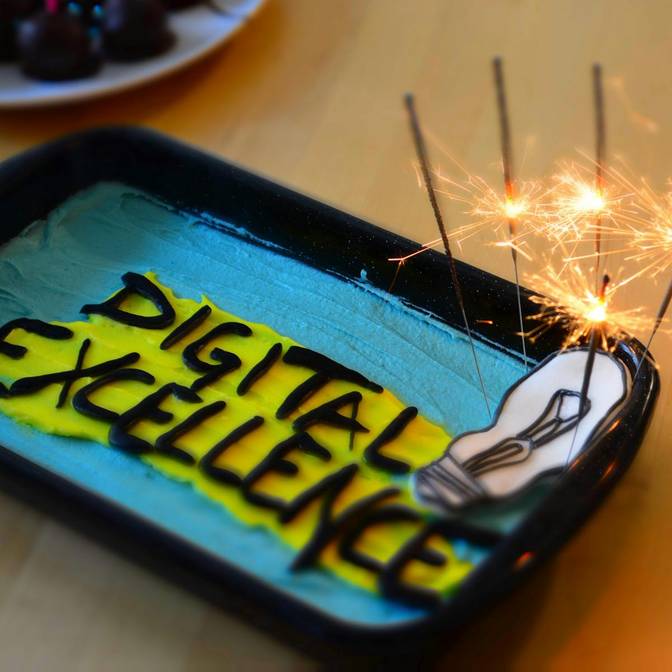 A cake with sparklers for Tickaroo's ninth birthday and the words digital excellence written out on it. Celebrating and looking forward to even more success in providing live reporting technology and custom digital solutions.